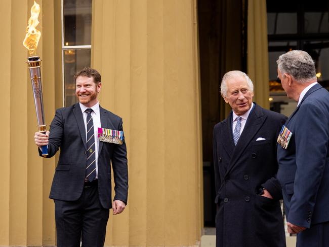 King Charles at Buckingham Palace with Dan Keighran and the Legacy torch. Pic: Callum Smith