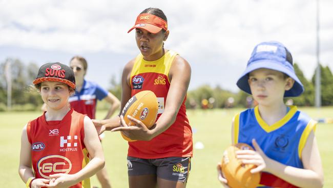 Suns player Janet Baird coaching football skills at Metricon Stadium. (Photo by Glenn Hunt/Getty Images)