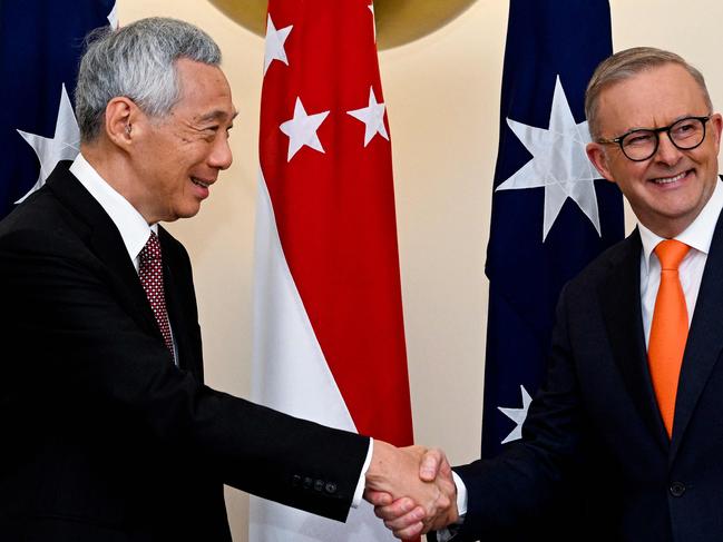 Australia's Prime Minister Anthony Albanese (R) shakes hands with Singapore's Prime Minister Lee Hsien Loong during their meeting at Parliament House in Canberra on October 18, 2022. (Photo by LUKAS COCH / POOL / AFP)