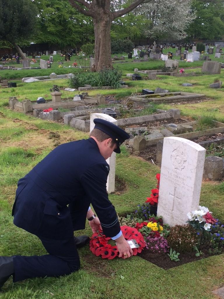 RAAF Flight Lt Adam Gunthorpe lays a wreath on the grave of Warrant Officer John Burrows on Anzac Day, 2018.