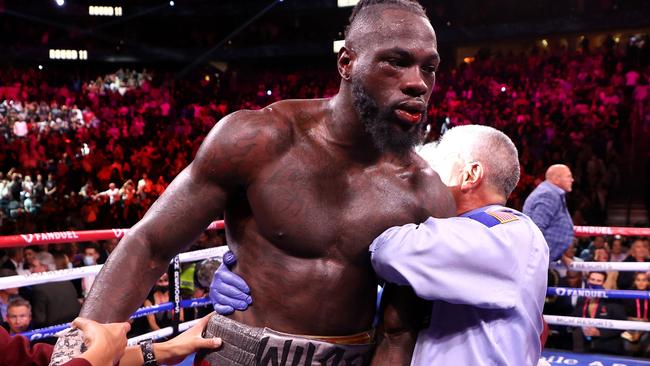 Wilder was in a very bad way and had to be assisted from the ring. (Photo by Al Bello/Getty Images)