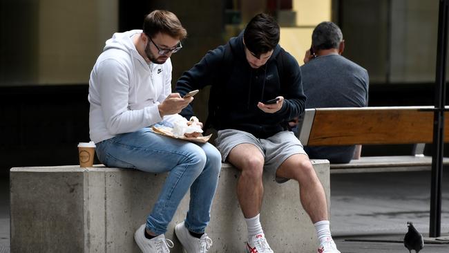 People are seen sitting close together, despite social-distancing advice in Sydney on March 24. Picture: AAP Image/Bianca De Marchi