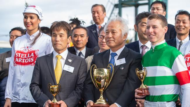 Caulfield Cup Day at the Melbourne Racing Club, Caulfield Racecourse.Race 9 the Stella Artois Caulfielf Cup, won by Mer De Glace, ridden by Damian Lane and trained by Hisashi Shimizu. Hisashi and Damian with the owner, Hiroaki Akita (holding the Cup).Picture Jay Town