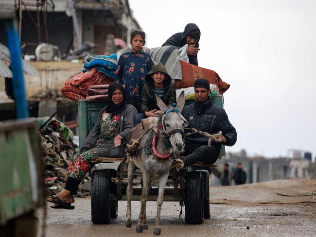 Palestinians use a donkey-pulled cart to transport their belongings as they flee Beit Lahia in the northern Gaza Strip. Picture: AFP