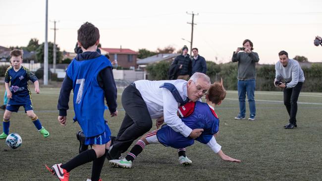 Herald Sun photographer Jason Edwards was awarded Photograph of the Year for this incredible shot of former Prime Minister Scott Morrison accidentally tackling a small boy on the federal election trail. Picture: Jason Edwards