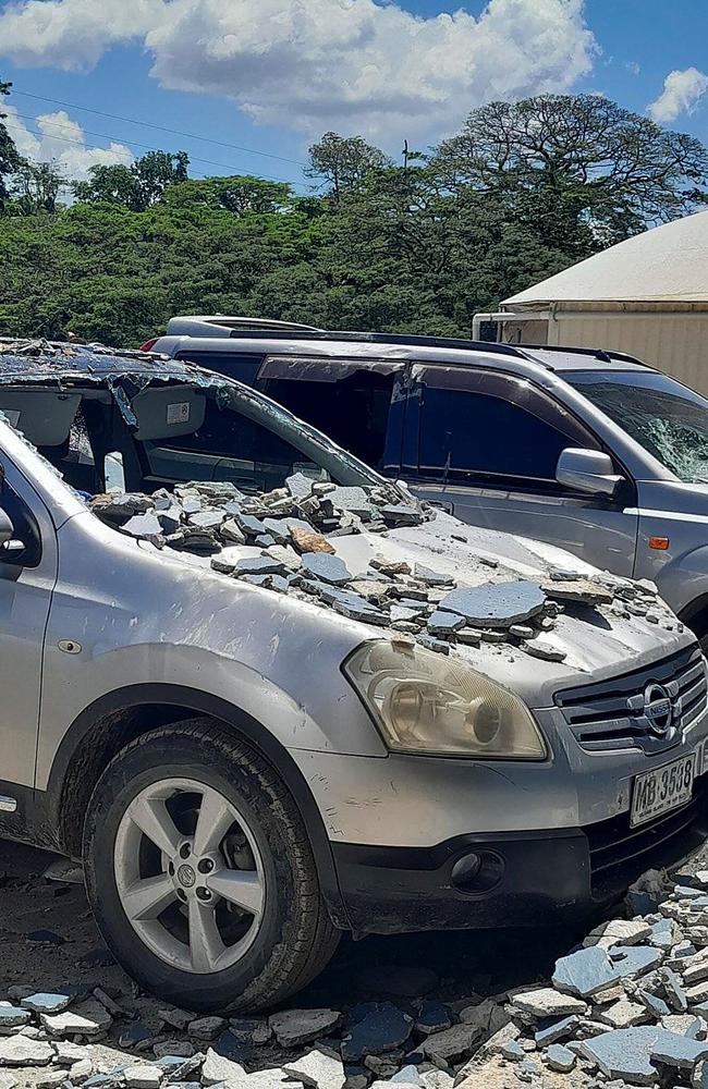 Damaged cars outside a building in Honiara. Picture: AFP.