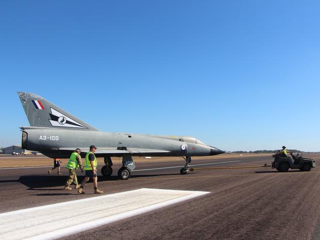 The Mirage is towed along the tarmac at RAAF Base Darwin under the supervision of the Static Display Aircraft Support team.