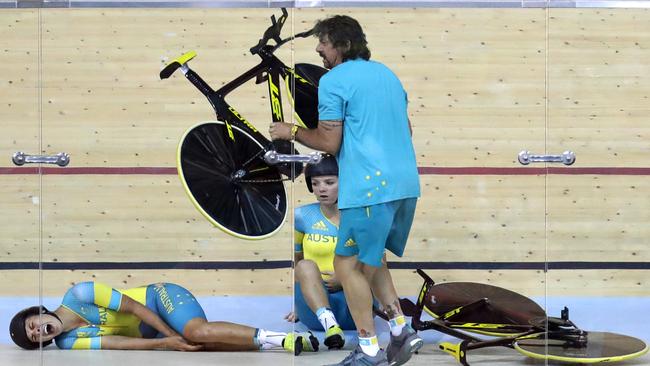 Melissa Hoskins, left, reacts after crashing during a training session inside the Rio Olympic Velodrome on Monday.