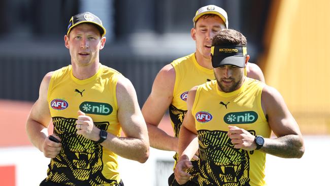 Dylan Grimes runs laps with Tom Lynch and Jack Graham during Thursday’s training session Picture: Michael Klein