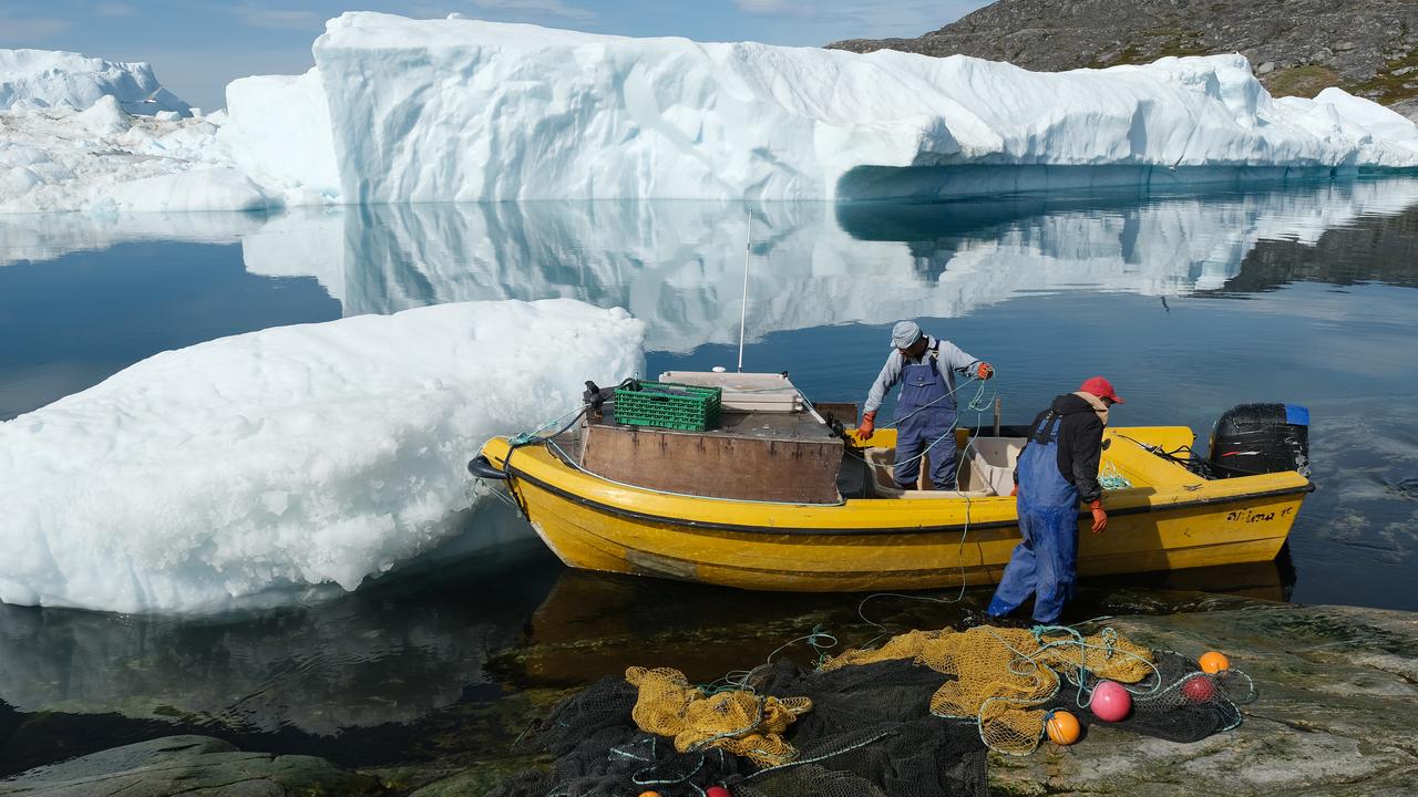 Inuit fishermen prepare a net among the free-floating ice. Picture: Sean Gallup/Getty Images