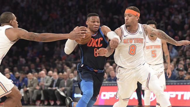 Oklahoma City Thunder guard Russell Westbrook drives to the basket between New York Knicks forward Michael Beasley.