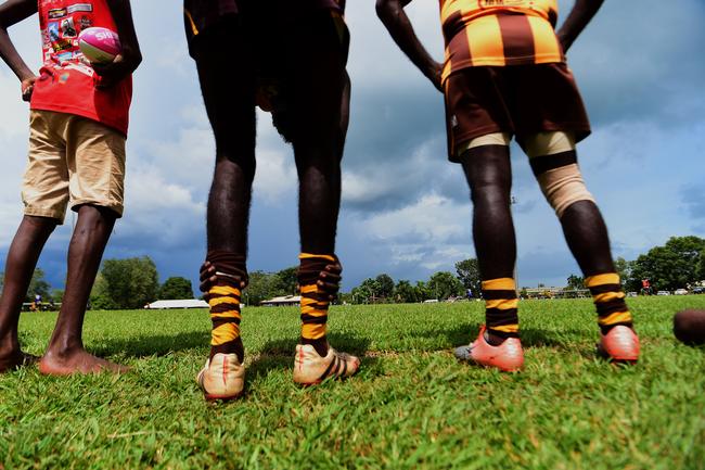 Tapalinga Superstars players watch the game as a storm rolls by during the grand final match against the Ranku Eagles during this year's 49th Annual Tiwi Grand Final on Bathurst Island, 80km's north of Darwin, NT. Picture: Justin Kennedy Picture: Justin Kennedy