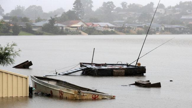 Boats and private wharves on the Gold Coast are swamped by rising floodwater. Picture: Scott Powick