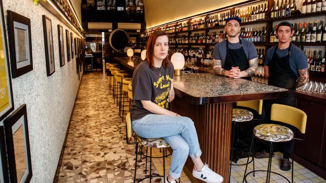 Leigh St Wine Room owners Sali Sasi (sitting), Nathan Sasi and Jake Kellie have been told they cannot serve people at their "bar", even though it's a non-service bar. Picture: Matt Turner