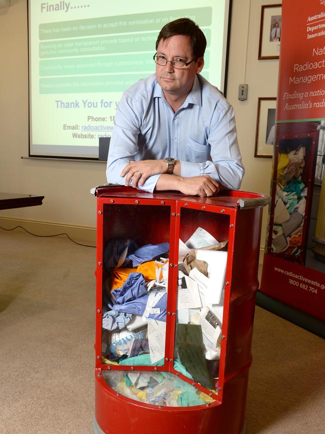 Bruce Wilson from the Department of Industry, Innovation and Science, with simulated low-level radioactive waste drum. Picture Campbell Brodie