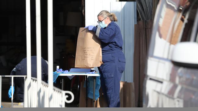 Police examine rubbish from the bins at an address in Coolaroo investigating a suspected homicide where a woman’s body was found in a rubbish tip at Epping. Saturday, July 6. 2024. Picture: David Crosling