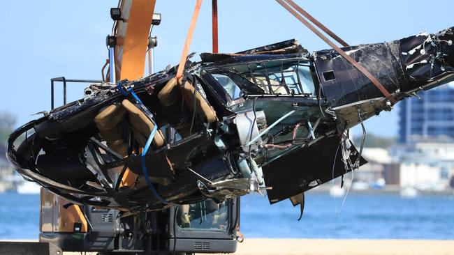 Queensland Police and ATSB Officers recover the wreckage after four people were killed in the collision. Picture: Scott Powick