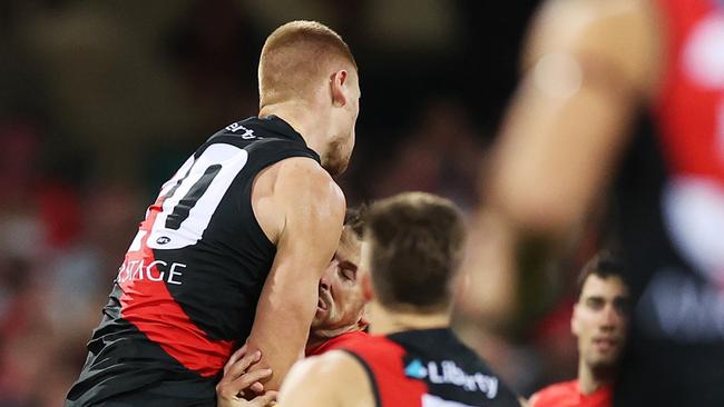 Essendon forward Peter Wright (left) has been suspended for four weeks after concussing Sydney’s Harry Cunningham in a marking contest last week. Picture: Mark Metcalfe / Getty Images