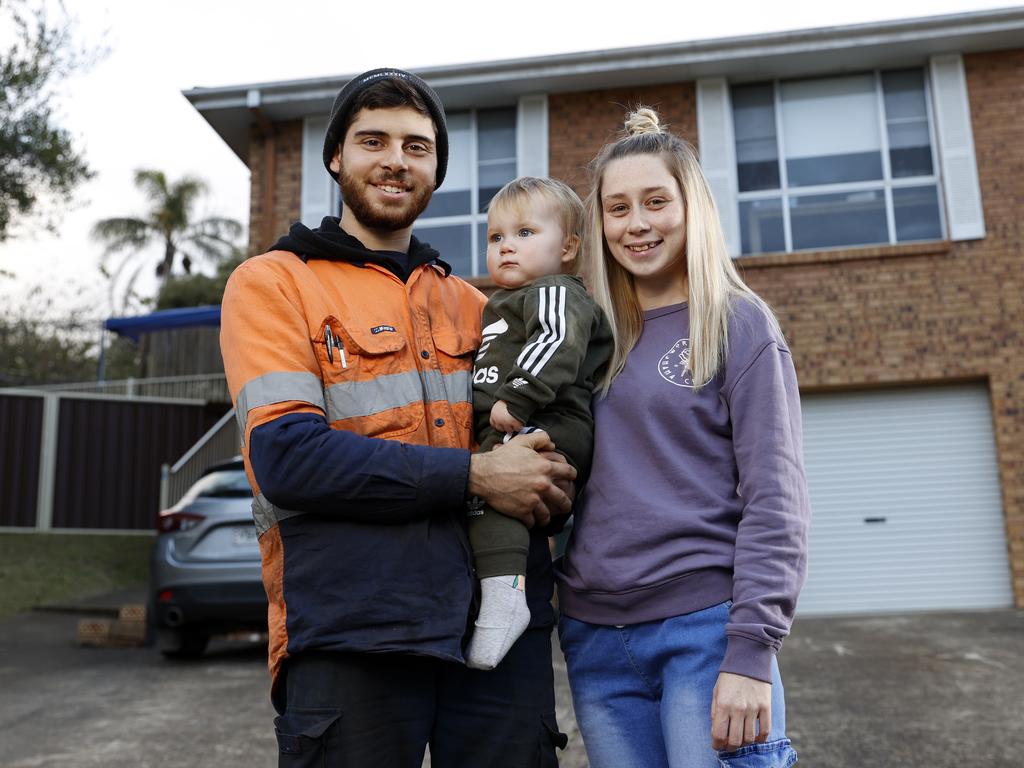 Holly Mulley, 24, and partner Alex McDonald, 25, pictured with their 14-month-old son Hunter McDonald at their rental home in Ambarvale. Picture: Jonathan Ng