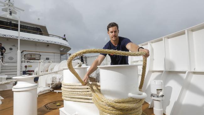 Small ship company Coral Expeditions has successfully resumed Australian cruises: deckhand Mitch Patterson in action. Picture: Sean Davey