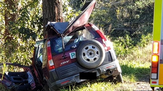 A man was trapped in his car after it smashed into a tree on Tin Can Bay Rd, early Monday morning. Photos: Frances Klein