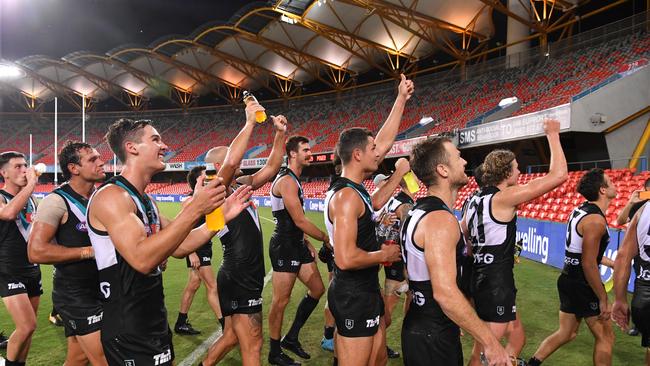 Power players leaving the field after beating Gold Coast on Saturday night – a day before the AFL postponed the competition. Picture: AAP/Darren England