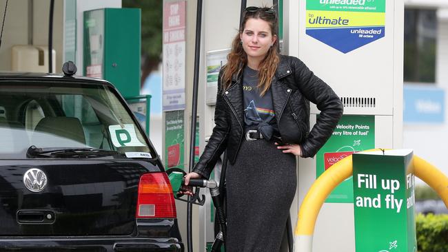 A motorist filling up the car with petrol. Photographer: Liam Kidston.