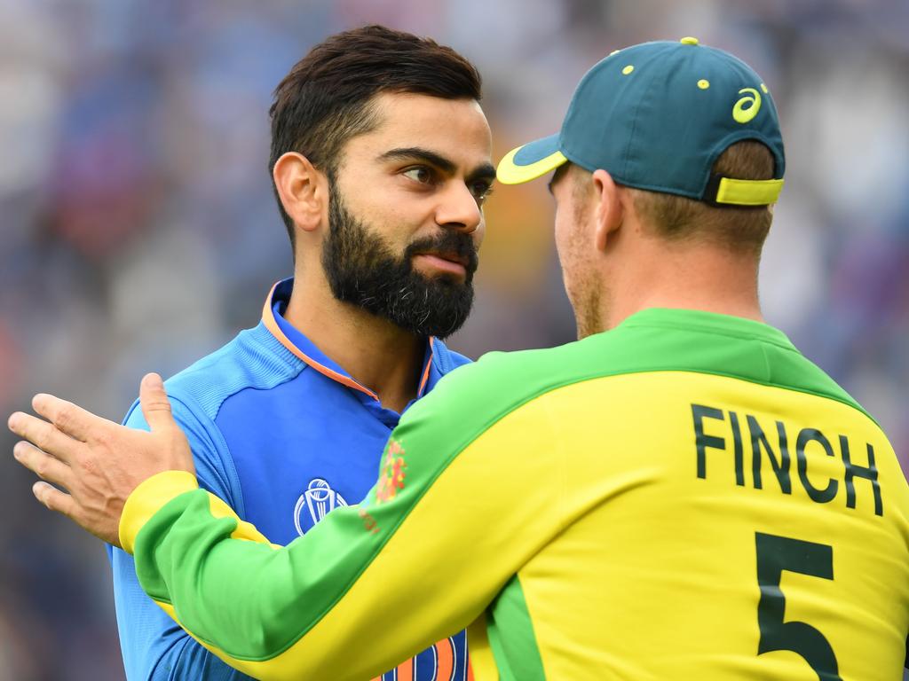 India's captain Virat Kohli shakes hands with Australia's captain Aaron Finch. (Photo by Dibyangshu SARKAR / AFP)