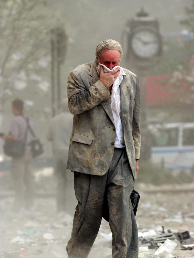 A businessman makes his way out of the rubble.