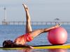 25/10/14 Simon Trangmar and Sally Danbury at Seacliff beach doing pilates on surfboards. photo Calum Robertson