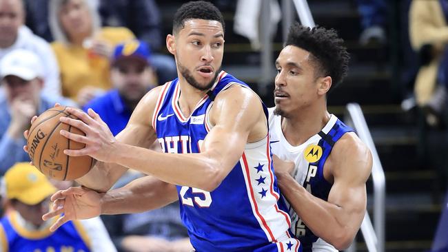 INDIANAPOLIS, INDIANA - JANUARY 13: Ben Simmons #25 of the Philadelphia 76ers dribbles the ball while defended by Malcolm Brogdon #7 of the Indiana Pacers at Bankers Life Fieldhouse on January 13, 2020 in Indianapolis, Indiana. NOTE TO USER: User expressly acknowledges and agrees that, by downloading and or using this photograph, User is consenting to the terms and conditions of the Getty Images License Agreement. Andy Lyons/Getty Images/AFP == FOR NEWSPAPERS, INTERNET, TELCOS &amp; TELEVISION USE ONLY ==