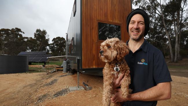 Luke with his dog Daisy outside the Tiny House. Picture: David Caird