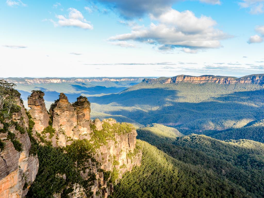 <span>6/50</span><h2>The Three Sisters, NSW</h2><p>The towering limestone rocks that make up the <a href="https://www.bluemts.com.au/info/thingstodo/threesisters/" target="_blank">Three Sisters </a>rise from a sandstone plateau set in a 760m deep gorge, near <a href="https://www.escape.com.au/destinations/australia/nsw/dont-delay-your-stay-a-complete-travel-guide-to-visiting-katoomba/news-story/70294e626ba24c101839f64f8784b72e" target="_blank" rel="noopener">the town of Katoomba</a>. Surrounding these iconic landmarks are some of the world’s oldest plant species, such as the Wollemi pine. A picture taken here is on every traveller’s bucket list, so make sure it’s on yours, too!</p>