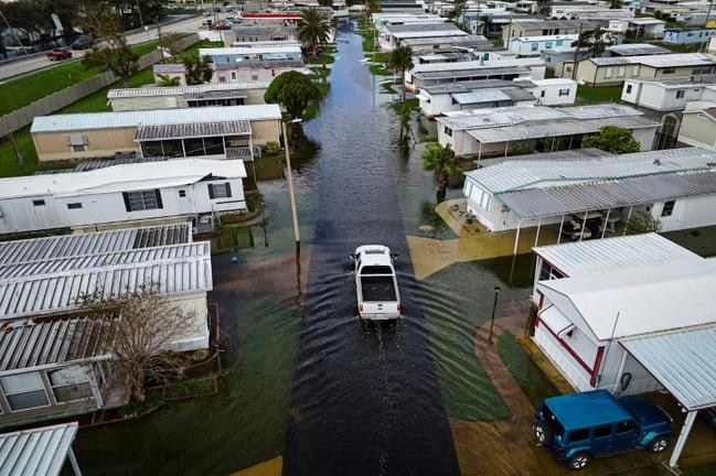 An aerial view shows a truck driving through a flooded street in the aftermath of Hurricane Milton in South Daytona, Florida