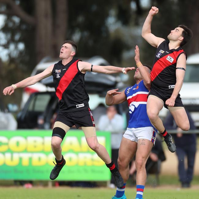 Waaia players outnumber Strathmerton’s Darcy Robinson.