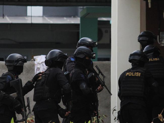 Indonesian anti-terror police conduct a raid at a house in Batam. Picture: AFP/Romy