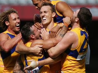 AFL : Round 1 :  North Melbourne v West Coast Eagles at Etihad Stadium, 26th March , Melbourne Australia.  West Coast's Drew Petrie celebrates his first goal in the fourth quarter as his team mates get around him. Picture : George Salpigtidis