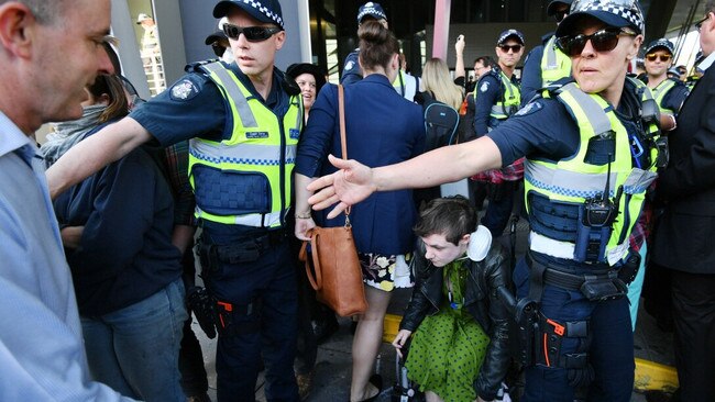 Police help conference delegates inside. Picture: Jake Nowakowski