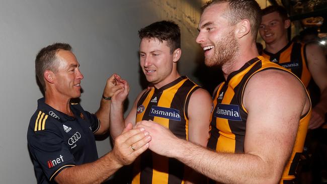 Alastair Clarkson celebrates the win over Geelong with Liam Shiels and Tom Mitchell.