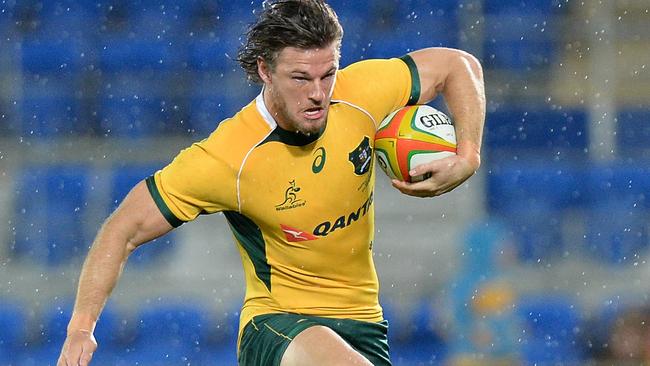 GOLD COAST, AUSTRALIA - SEPTEMBER 13: Rob Horne of the Wallabies breaks through the defence during The Rugby Championship match between the Australian Wallabies and Argentina at Cbus Super Stadium on September 13, 2014 in Gold Coast, Australia. (Photo by Bradley Kanaris/Getty Images)