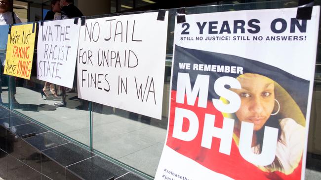 Signs put up by supporter of Ms Dhu outside the coroner's court in Perth on Friday, Dec. 16, 2016. The State Coroner concluded Ms Dhu was the victim of unprofessional treatment leading to her death. (AAP Image/Richard Wainwright).