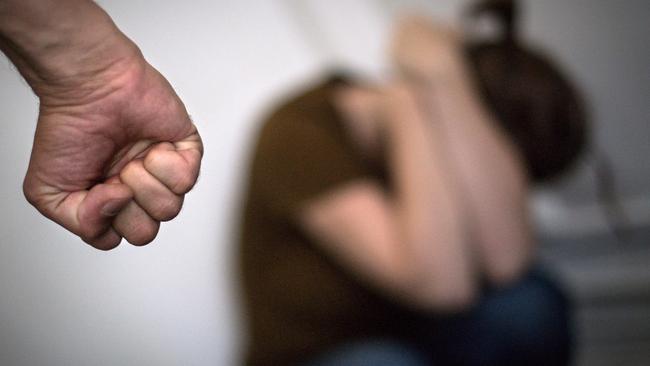 This illustration photograph taken on September 2, 2019, shows a woman hiding her face in front of a man's fist in Nantes, replicating a supposed scene of domestic violence. - On September 1, 2019, activists gathered on Trocadero Square in front of Paris' iconic Eiffel Tower some carrying placards with numbers ending at 100, to mark the country's 100th femicide of 2019. A total of 121 women were killed by their partner or former partner in France in 2018, equating to one death every three days, government figures showed in July 2019. (Photo by LOIC VENANCE / AFP)