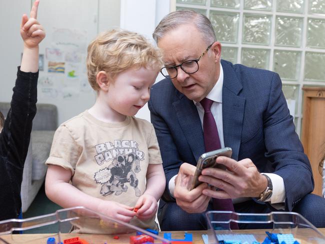 CANBERRA, AUSTRALIA - NewsWire Photos FEBRUARY 9, 2023: L-R: Bradley Gosper, Prime Minister, Anthony Albanese and Olivia Castrisson. The PM was showing Bradley his dog on his phone.Prime Minister, Anthony Albanese with the Minister for Education, Jason Clare, the Minister for Early Childhood Education, Dr Anne Aly and Alicia Payne, the Member for Canberra during a visit to the Manuka Childcare Centre.Picture: NCA NewsWire / Gary Ramage