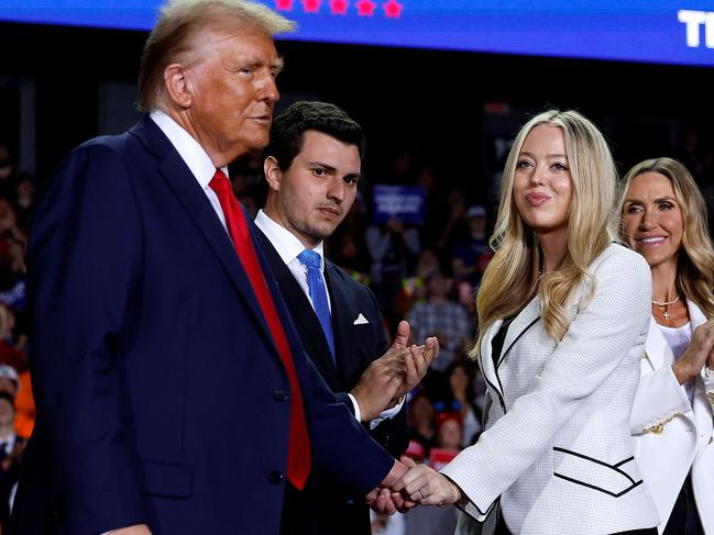 GRAND RAPIDS, MICHIGAN - NOVEMBER 05: Republican presidential nominee, former U.S. President Donald Trump, (L) shakes hands with daughter Tiffany Trump as they are joined on stage by Tiffany's husband Michael Boulos, RNC Co-chair Lara Trump and Donald Trump Jr. during Trump's final campaign rally of the election year at Van Andel Arena on November 05, 2024 in Grand Rapids, Michigan. Trump campaigned for re-election in the battleground states of North Carolina and Pennsylvania before arriving for his last rally minutes after midnight in Michigan.   Chip Somodevilla/Getty Images/AFP (Photo by CHIP SOMODEVILLA / GETTY IMAGES NORTH AMERICA / Getty Images via AFP)