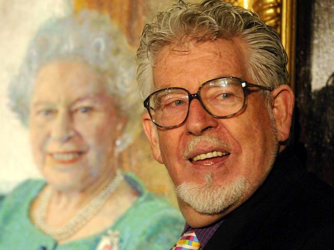 Harris beside his portrait of Queen Elizabeth II at Buckingham Palace in London in 2006.