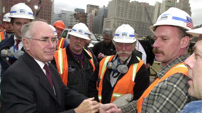 John Howard with workers at the World Trade Centre site in New York during a tour of the scene on January 30, 2002. Picture: Ray Strange