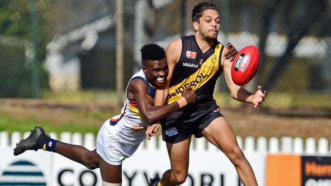 Adelaide's Aron Asfaha tackles Glenelg's Ian Milera when the two sides clashed at Glenelg Oval on Saturday. Picture: Tom Huntley