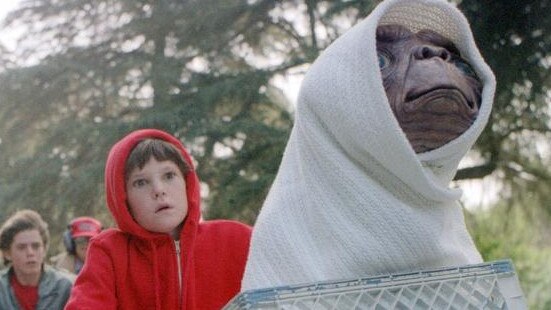 This undated studio handout shows Elliott, played by Henry Thomas, his brother and friends riding as fast as they can from the police to get "E.T. The Extra-Terrestrial" back to the forest. Steven Spielberg's 1982 "E.T. The Extra-Terrestrial" returns to theaters Friday, updated with a couple of previously unreleased scenes, visual enhancements, improved sound and excisions that have annoyed some purists who dislike tampering with beloved films. (AP Photo/Bruce McBroom, Universal Studios Amblin Entertainment)