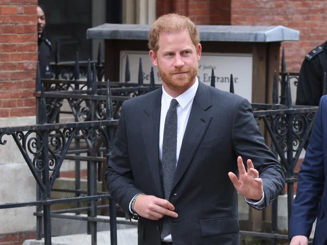 Prince Harry waves to supporters outside a London court. Picture: Getty Images