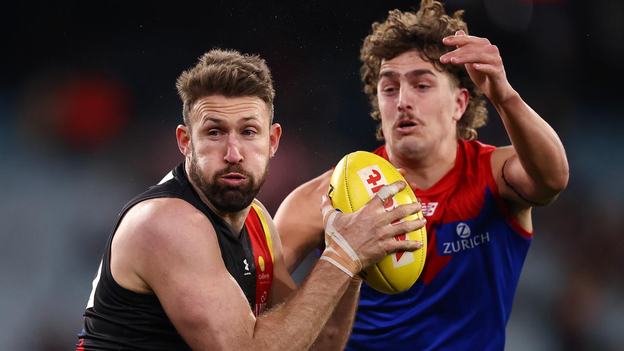 AFL Round15 . Essendon vs Melbourne at MCG, Melbourne. 26/06/2021. Cale Hooker of the Bombers takes possession in front of Luke Jackson of the Demons in the boundary throw in ruck contest . Pic: Michael Klein
